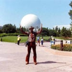 perspective shot of man in front of large ball structure